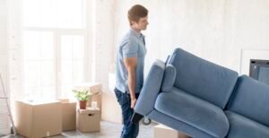 side-view-man-handling-couch-while-preparing-move-out